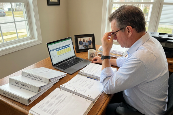 Business owner completing pre-sale business preparation checklist 12 months before exit